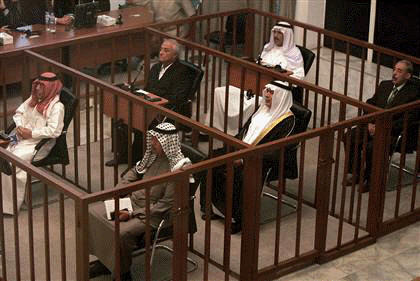 The six defendents in the Anfal trial sit in the dock at a courtroom in Baghdad